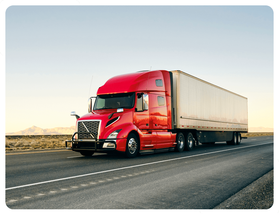 Red semi-truck driving on open highway.